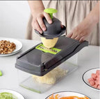Person using a mandoline slicer to slice potatoes on a kitchen counter.