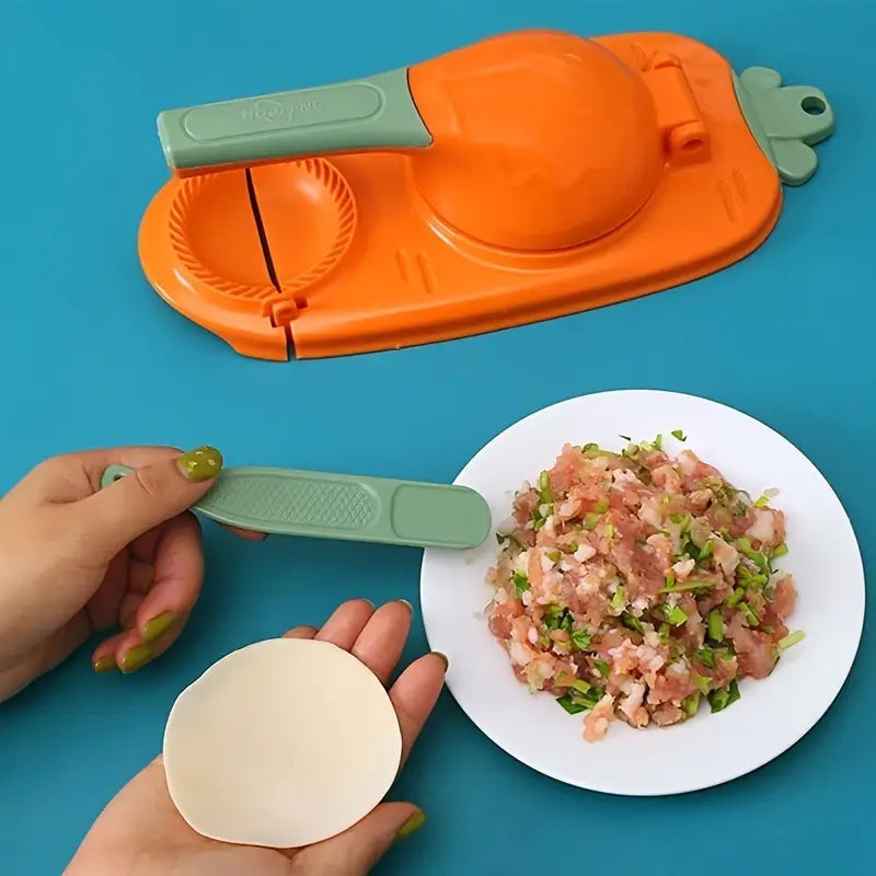 Orange meat grinder with a plate of ground meat and a hand holding a piece of dough on a blue background
