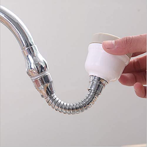 Hand holding a white kitchen sprayer with a flexible hose attached to a faucet on a light gray background