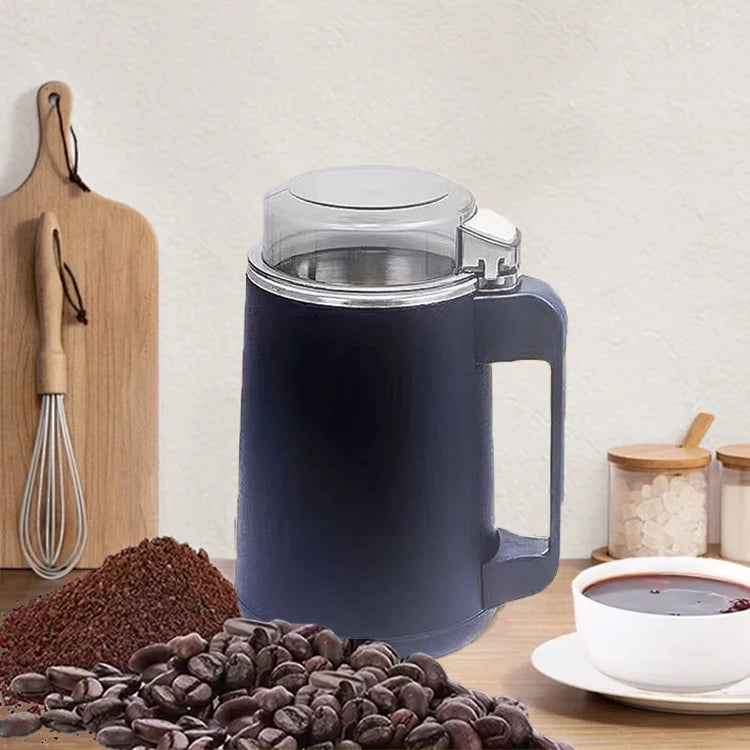 Blue electric coffee grinder with coffee beans and a cup of coffee on a wooden surface.