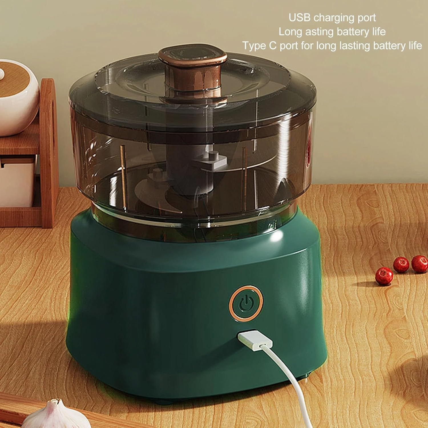 Green food processor on a wooden surface with USB charging cable