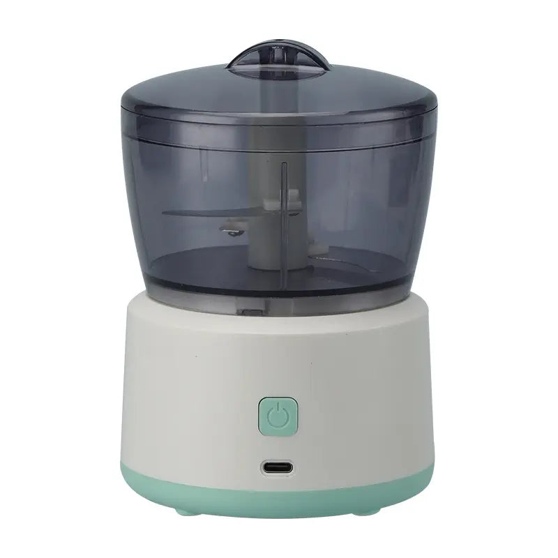 Small food processor with a clear top and white base on a white background