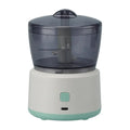 Small food processor with a clear top and white base on a white background