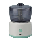 Small food processor with a clear top and white base on a white background