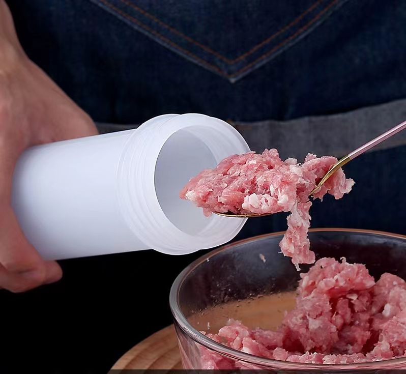 Person using a white container to scoop ground meat into a metal bowl.
