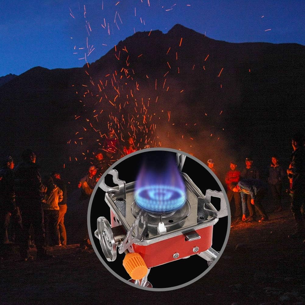 Close-up of a camping stove with people and fireworks in the background