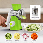 Green kitchen slicer with sliced vegetables on a countertop