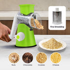Green manual grater with shredded ingredients on a kitchen counter, showing uses for nuts, chocolate, cookies, and cheese.