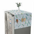 Fridge with a decorative cover featuring kitchen utensils and plants on a white background