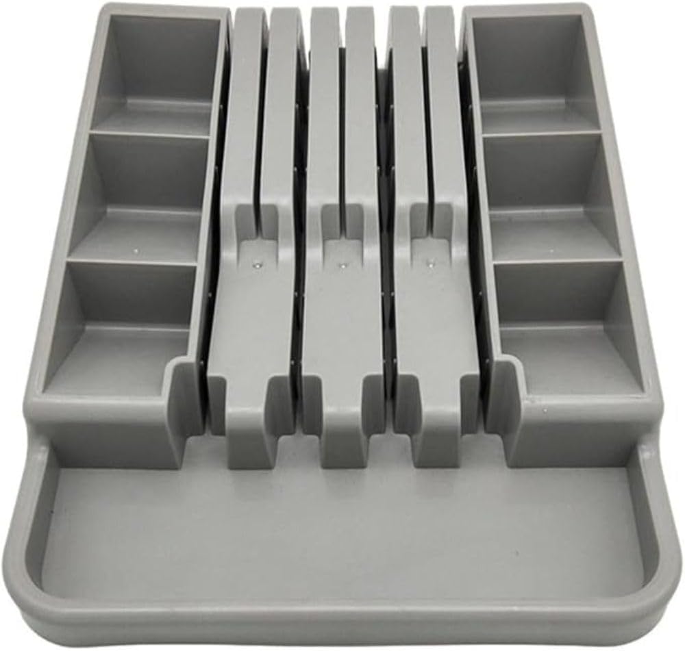 Gray plastic cutlery organizer with multiple compartments on a white background