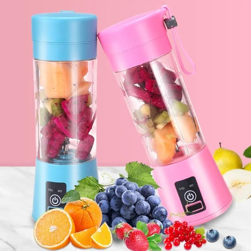 Two portable blenders, one blue and one pink, filled with fruits on a pink background.