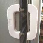Close-up of a refrigerator handle with a white cover on a gray refrigerator.