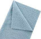 Folded light blue towel on a white background