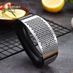 Metal grater with black handle on a dark surface, with 'WORTHBUY' branding.