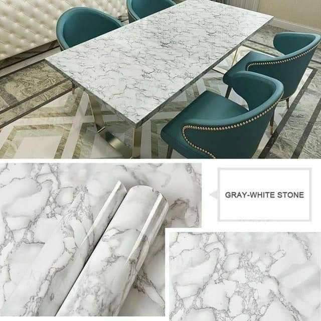 Dining table with marble-like surface and teal chairs, with close-up of marble texture.